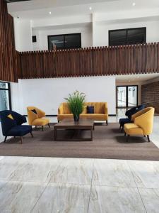 a lobby with couches and a table and chairs at Guatemala, departamento ciudad capital zona 12. in Guatemala