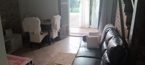 a living room with a leather couch and a table at Apartments Relax Zone in Umag