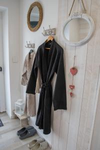 a coat and shoes are hanging on a wall at Chambre indépendante n2 - Bretzel et Bergamote in Richtolsheim