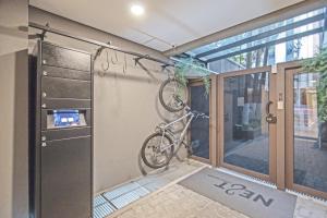 a bike hanging on the wall of a house at Next Home Design by Viva - Apartamentos em prédio próximo ao Parque do Ibirapuera in Sao Paulo +34 photos