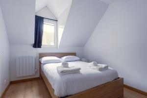 Un dormitorio con una cama con dos toallas encima. en L'Elias : appartement de standing pour 6, en Rouen