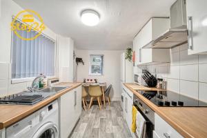 a kitchen with a sink and a stove top oven at Mill House Manor in Crewe