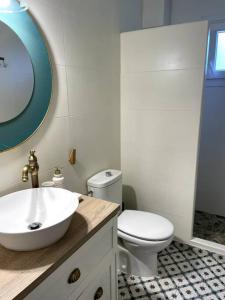 a white bathroom with a sink and a toilet at Vida Soladana - Cala en Forcat - piscina, playa, A/C, Smart TV... in Cala en Forcat