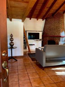 sala de estar con sofá y chimenea en Cabaña la Toscana, en Mazamitla