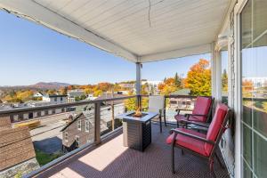 a patio with two chairs and a table on a balcony at Amazing Mountain Views Lake Placid & 1980 Olympic Center in Lake Placid