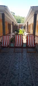 two red and white chairs sitting on a patio at Hostal Miraflores B&B in Santo Domingo