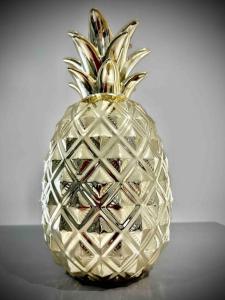 a silver pineapple sitting on top of a table at 2 Bedroom House -Sleeps 7- Big Savings On Long Stays! in Canterbury