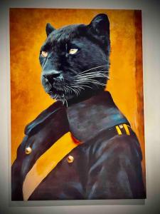 a painting of a black cat wearing a jacket at 2 Bedroom House -Sleeps 7- Big Savings On Long Stays! in Canterbury