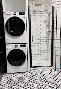 a washer and dryer in a bathroom with a shower at Romantic West End Apartment with Parking in Portland