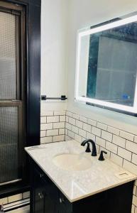 a bathroom with a sink and a window at Romantic West End Apartment with Parking in Portland +8 photos