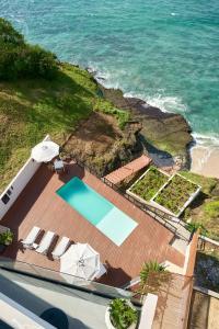 an aerial view of the ocean and a swimming pool at Hotel Basalto in Punta Mita