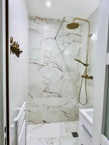 a bathroom with a marble shower with a glass door at Paris rare pearl 5e Notre Dame Saint Michel in Paris