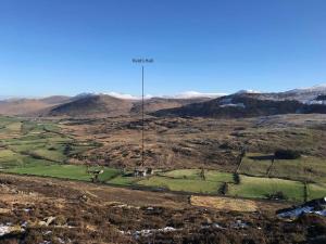an aerial view of a mountain with a pole on it at Reid's Hall in Hilltown