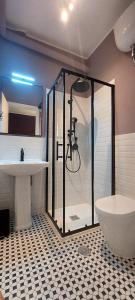 a bathroom with a shower and a toilet and a sink at Iaio River Suite in Rome