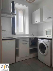 a white kitchen with a washing machine in it at Studette Cosy Seh’Loué in Saint-Brieuc