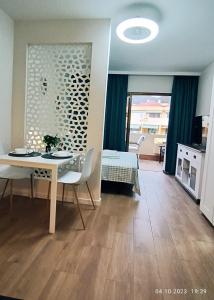 a living room with a table and a dining room at MNG-APART Studia Mareverde D-15 Costa Adeje in Adeje