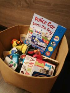 a police car saves the day book and toys in a box at Baby friendly 1-bedroom rental w/ free parking in Sigulda