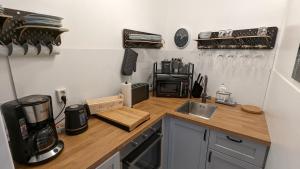 a kitchen with a counter top with a coffeemaker on it at Wald und Meer in Glücksburg