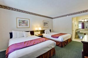 a hotel room with two beds in it at Americas Best Value Inn - Sky Ranch Palo Alto in Palo Alto