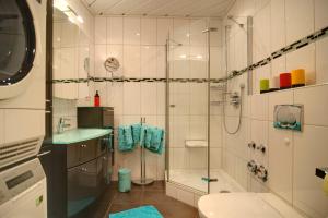 a bathroom with a shower and a sink at Ferienwohnung AMBIENTE in Bremerhaven +11 photos