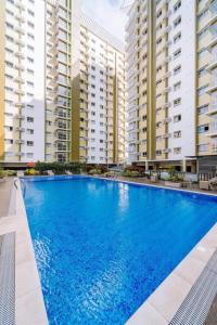 a large blue swimming pool in front of tall buildings at The Marys Place-Cozy&Modern Fully Furnished StudioType Condo at MesaVerte Residences in Cagayan de Oro