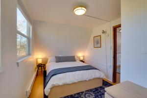 a small bedroom with a bed and two windows at Jefferson A-Frame Cabin with Rocky Mountain Views in Bordenville