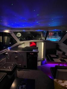 a view of the inside of a boat with purple lights at YACHT "X" - 44 FOOT MODERN YACHT ON 5 STAR OCEAN VILLAGE MARINA - minutes away from city centre and cruise terminals, Free parking ,SPA package available! in Southampton