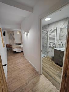 a hallway of a bathroom with a sink and a mirror at Apartamentos Santander 2 in Santander