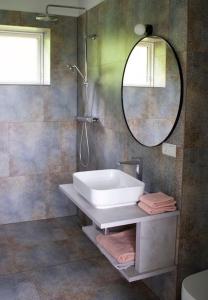 a bathroom with a tub and a mirror at Beautiful house with an outstanding view in Hvolsvöllur