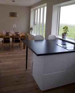 a kitchen and dining room with a table and chairs at Beautiful house with an outstanding view in Hvolsvöllur