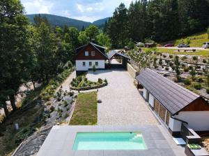 an aerial view of a house with a swimming pool at Apartmány - Chata Zadov in Prachatice