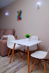 a white table and chairs in a living room at Elly Residence in Nairobi
