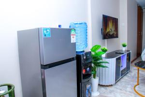 a kitchen with a refrigerator and a water cooler at Elly Residence in Nairobi