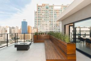 a balcony with a view of a city at Apartamento - Batel/Água Verde - Shopping Curitiba in Curitiba