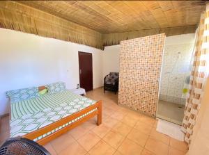a bedroom with a bed and a glass door at Le Dona Kribi in Kribi
