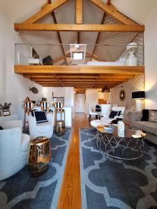 a living room with white furniture and wooden ceilings at Oporto Golden Apartment in Porto