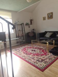 a living room with a couch and a rug at Glasgow City in Glasgow