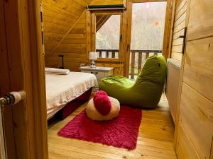 a teddy bear sitting on the floor of a bedroom at Cozy Cabin in the Woods in Brezovica
