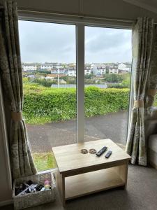 a coffee table in front of a large window at High View in Torquay