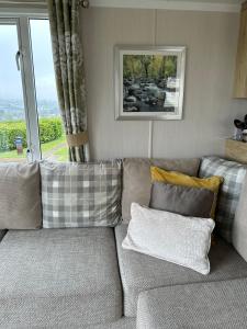 a living room with a couch and a window at High View in Torquay