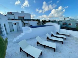 a group of chairs sitting on top of a roof at MAYAB Playa - 5Th. Ave in Playa del Carmen