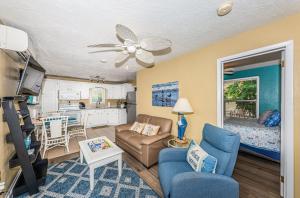 a living room with a couch and a table at Sunset Beach Bungalow 1 in St Pete Beach