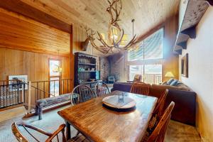 a dining room with a wooden table and a couch at Meadow Ridge 34 in Mammoth Lakes
