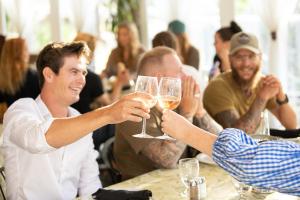 a group of people holding up glasses of wine at Kumsheen Rafting Resort in Lytton