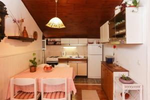 a small kitchen with a table and a sink at Apartment Ikana in Dubrovnik