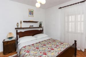 a bedroom with a bed with a quilt on it at Apartment Ikana in Dubrovnik