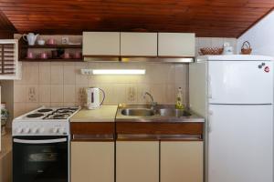 a kitchen with a sink and a white refrigerator at Apartment Ikana in Dubrovnik