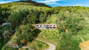an aerial view of a house on a hill at Hilltop Enchanting Villa with Stunning Views & Jacuzzi in Medellín