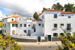 a large white building with red roofs at FOREST VILLAS - GUEST HOUSE in Leiria