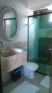 a bathroom with a glass shower and a toilet at Barcel Flat in Teresina